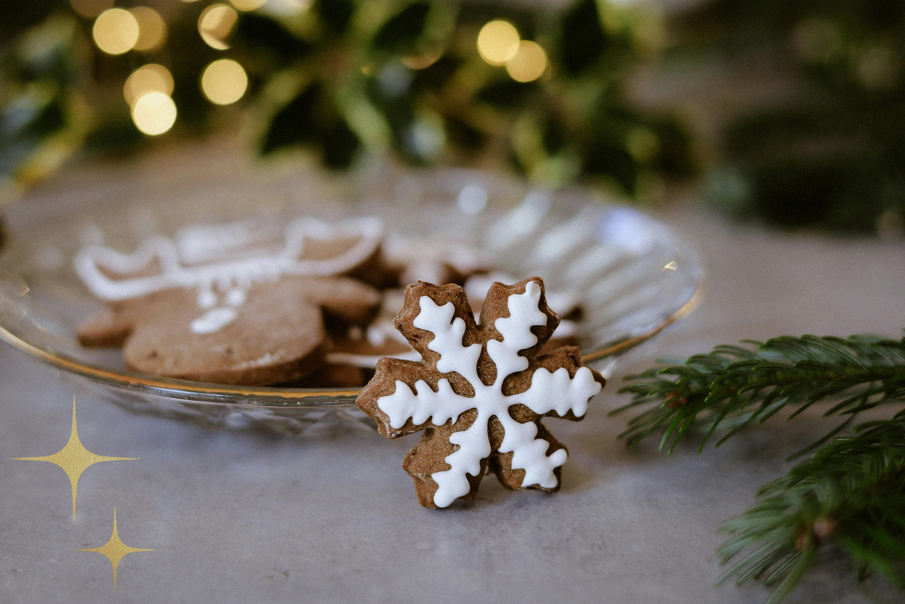 Snowflake gingerbread cookies  with white icing on a glass plate. 