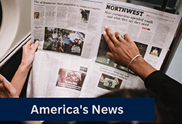 Photo taken from above of an open newspaper. Two different people are holding the newspaper and all you can see is their forarms and hands. 