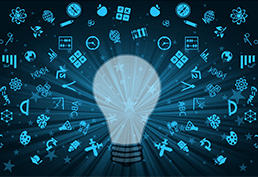 Lightbulb surrounded by an educational icons including microscope, brain, art pallet, compass, apple, pencil, globe, graph, beaker. 