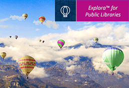 11 different hot air balloons flying through the clouds and over mountains. The photo is taken from the advantage point of another hot air balloon. 