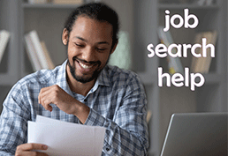 Bearded man smiling while reading papers with a laptop to his right. Text reads job search help. 