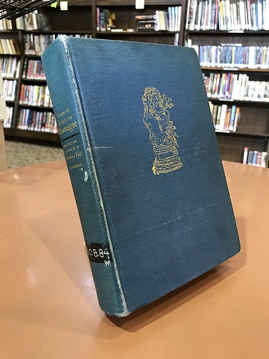Photo of blue book with gold imprint on the front.