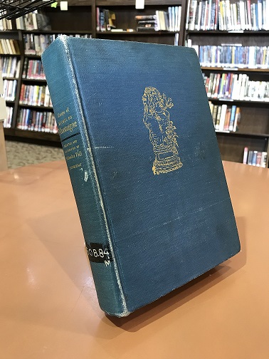 Photo of blue book with gold imprint on the front.
