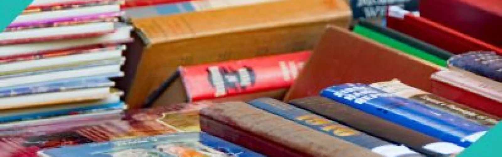 A variety of books stacked on each other. 