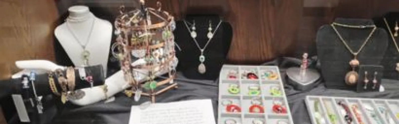 A variety of jewelry in a display case.