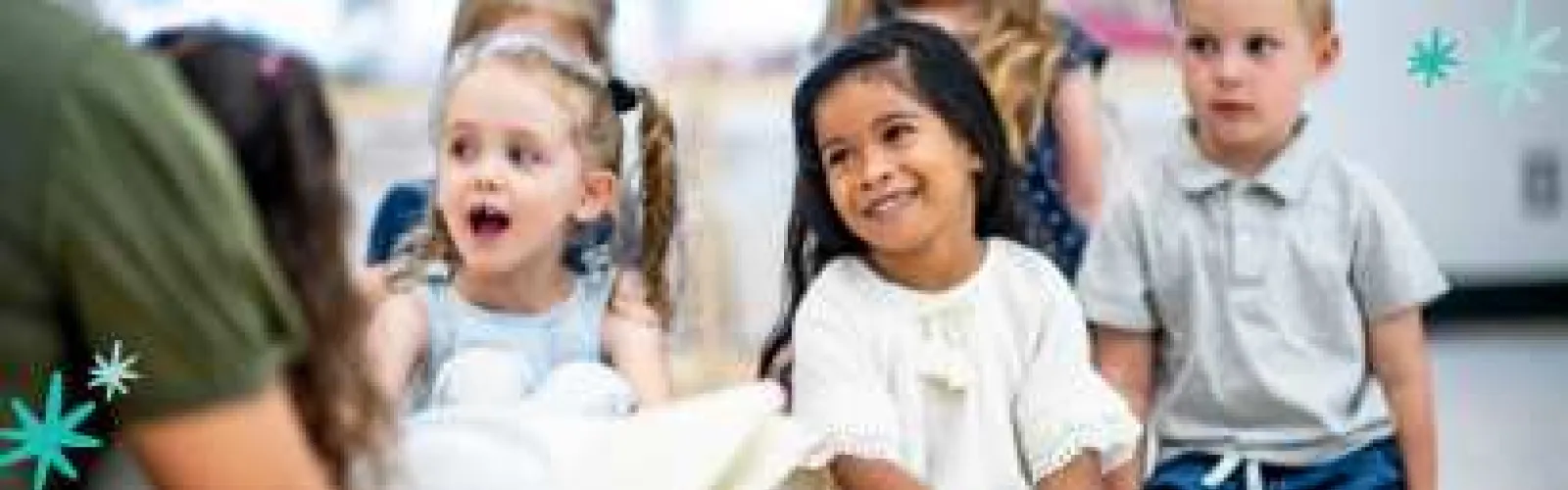 Kids listening to Storytime. Graphics of turquoise and pale blue stars in opposite corners. 