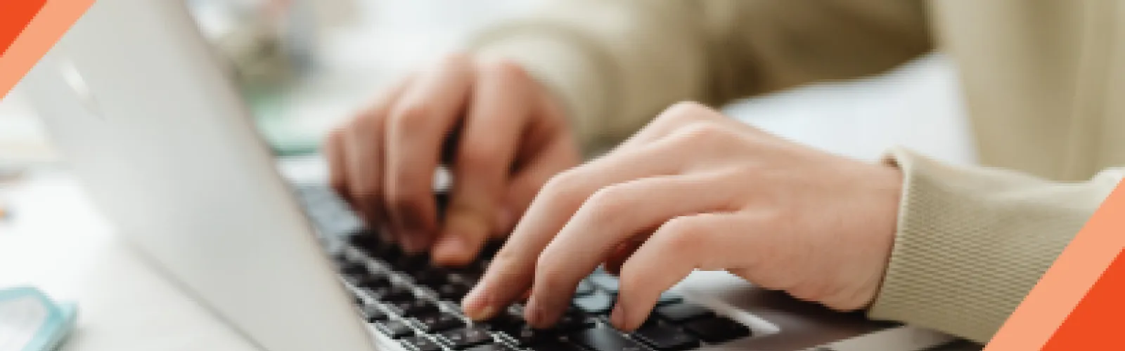 A person typing on a laptop.