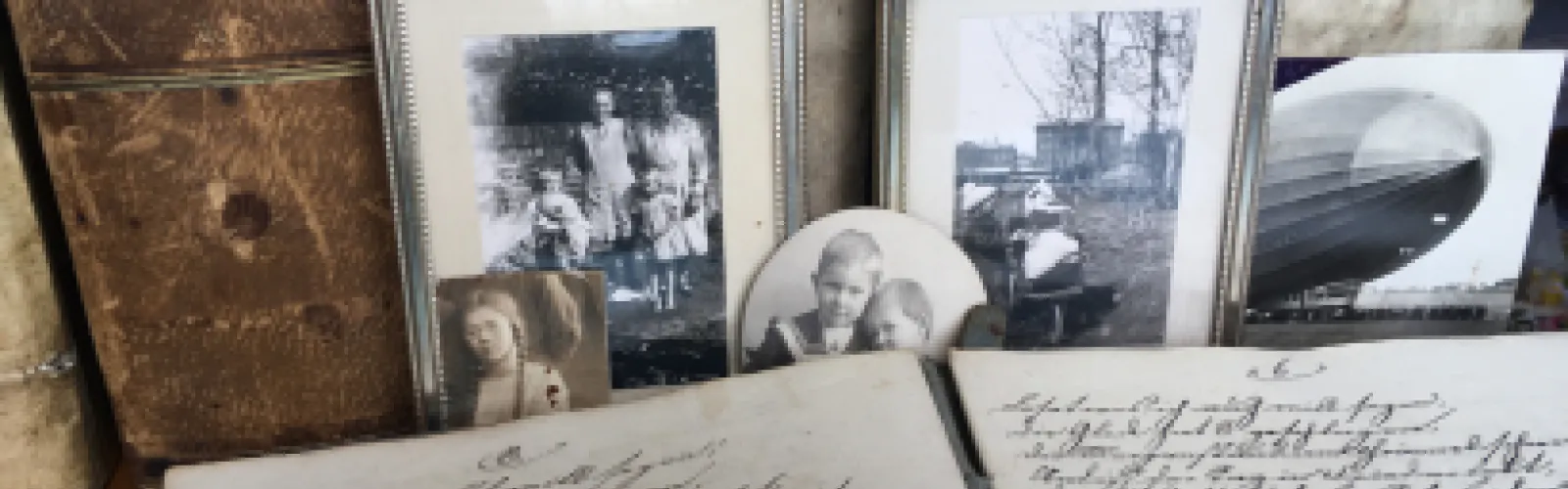 A picture of old family photos and records. 