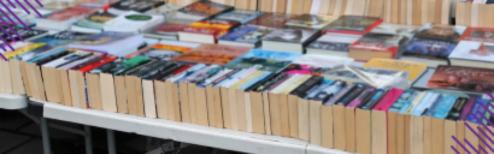 Rows of books on white tabs for sale. 