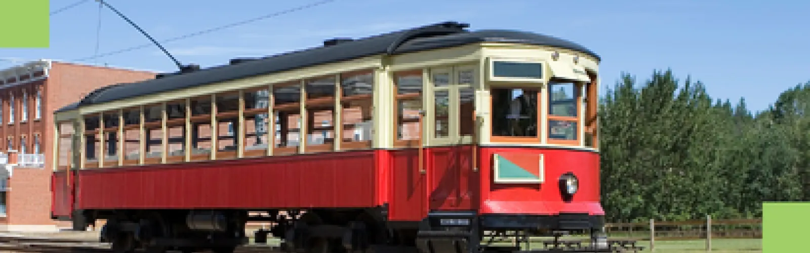 A picture of a red and tan street car.