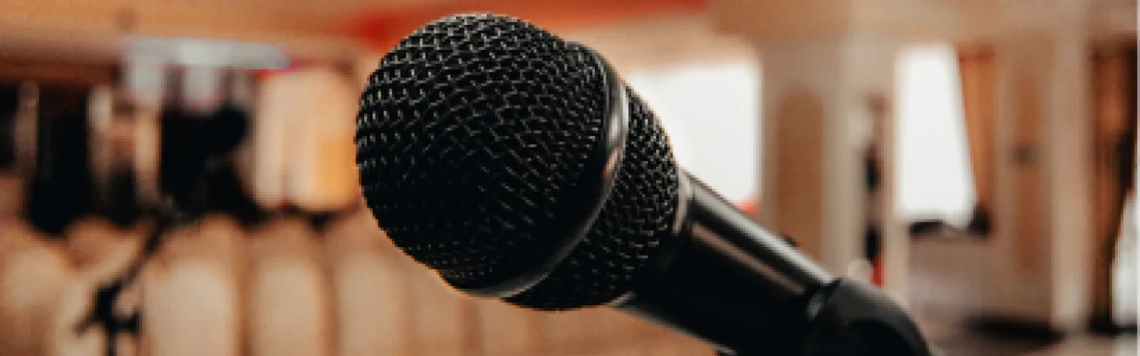 Microphone in from of the an auditorium of chairs. 